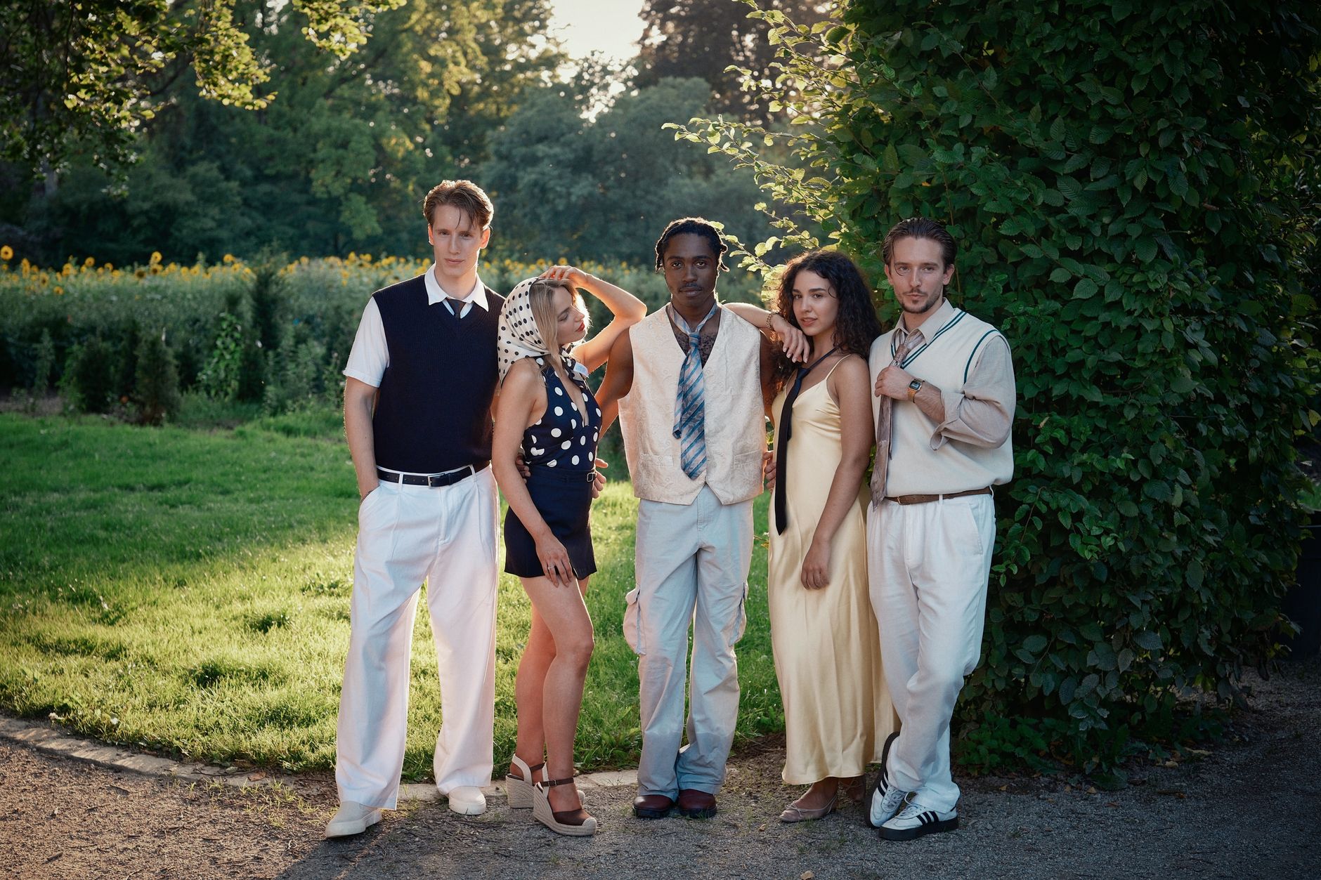 Five stylish young adults posing in a summer park, exuding modern fashion and confidence. — Grey Color - a New Fashion Trend