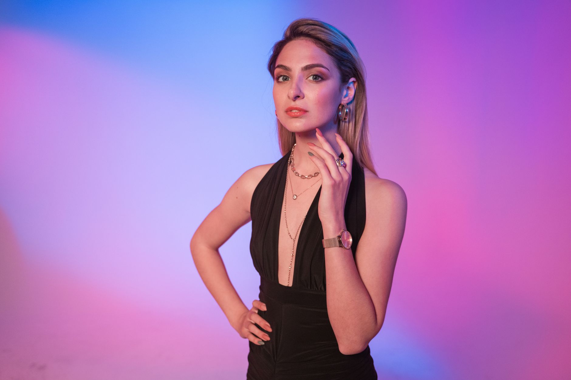 Portrait of a stylish young woman posing in a studio with colorful lighting. — Hats and their Production: A relevant Fashion